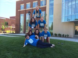 If the writing mentors were a band... Mary (modeling on grass) would be the bass player, Alex and Anthony (bottom, outside peeps) would be guitarists. Kristina (bottom middle) would be lead singer. Christine (blonde hair, middle row) would be on drums. Kolleen (top of pyramid) would break out the banjo. And then I would play a nice harmonica or tambourine. Not pictured: Prof. Carey Applegate, AKA Band Manager and makes an appearance on the triangle and cow bell.